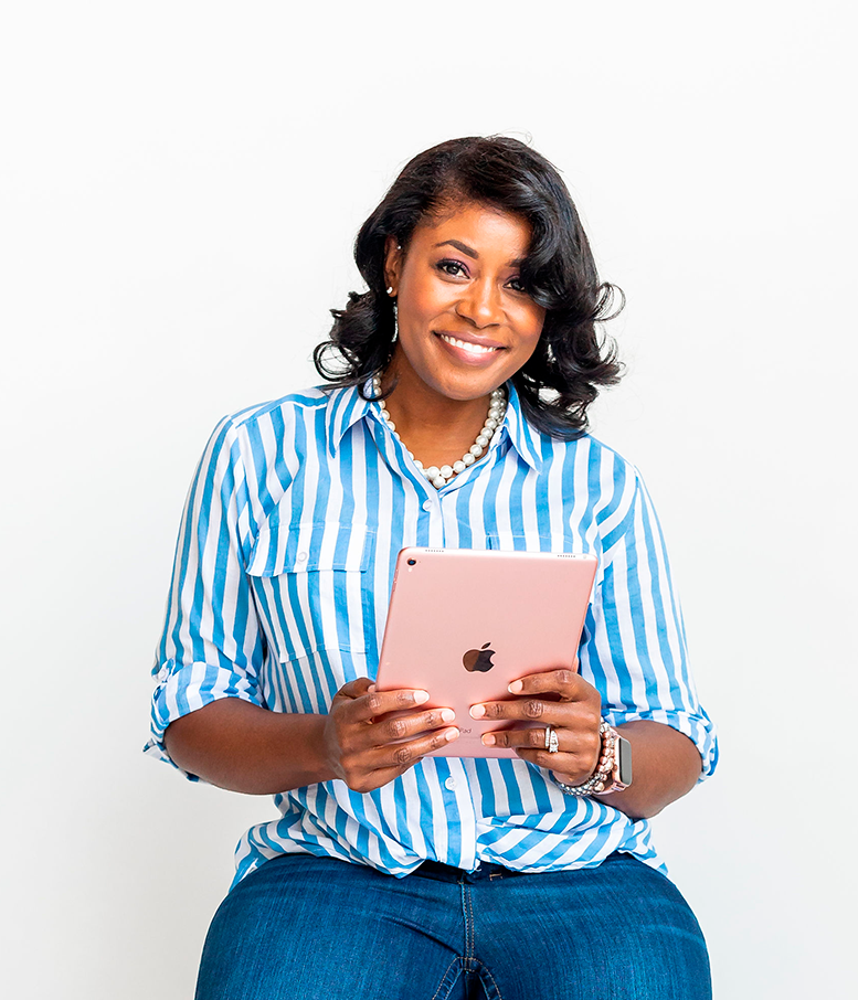 Woman wearing a blue polo shirt sitting down and holding an ipad